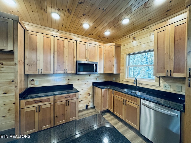 kitchen with sink, light hardwood / wood-style flooring, dark stone counters, wooden ceiling, and stainless steel appliances