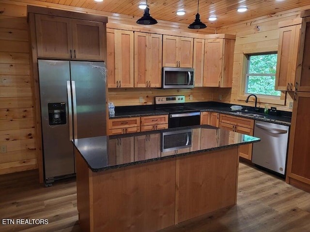 kitchen featuring pendant lighting, sink, wood ceiling, appliances with stainless steel finishes, and a center island