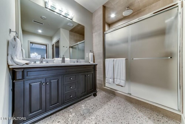 bathroom with vanity and an enclosed shower