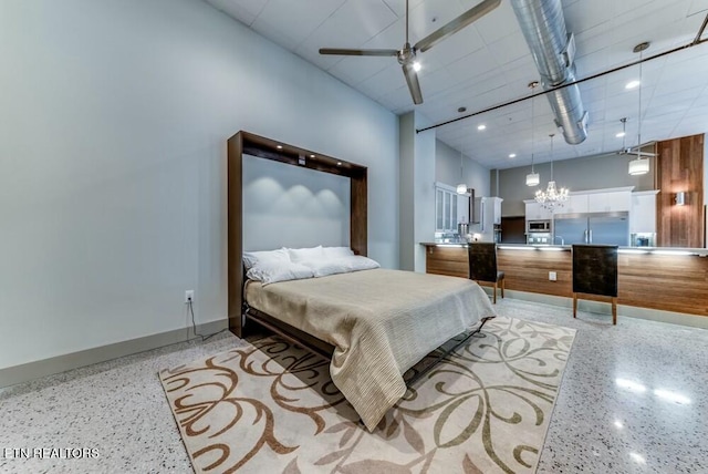 bedroom with stainless steel built in refrigerator and a chandelier