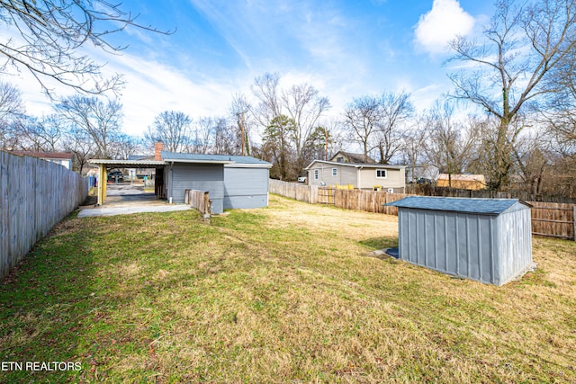 view of yard featuring a carport and a shed