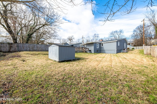 view of yard featuring central air condition unit and a storage shed