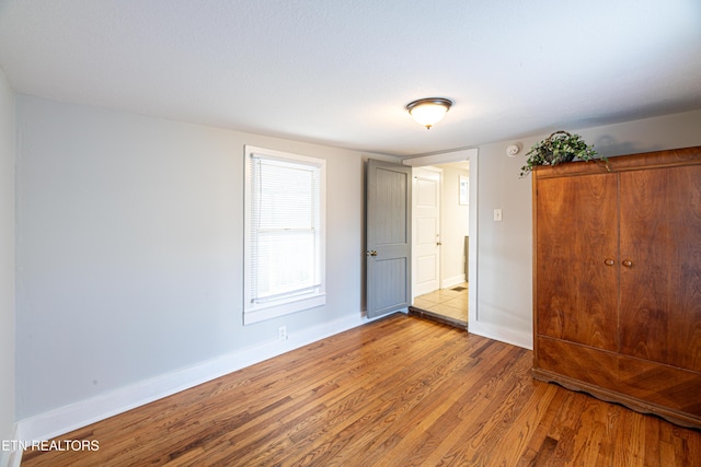 unfurnished bedroom with light wood-type flooring