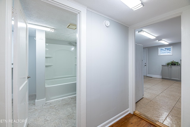 corridor with a textured ceiling