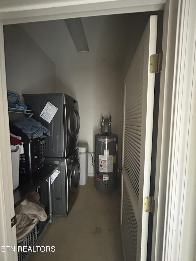 clothes washing area with gas water heater and stacked washer and clothes dryer