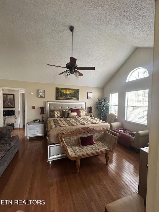 bedroom with dark hardwood / wood-style flooring, ceiling fan, lofted ceiling, and a textured ceiling