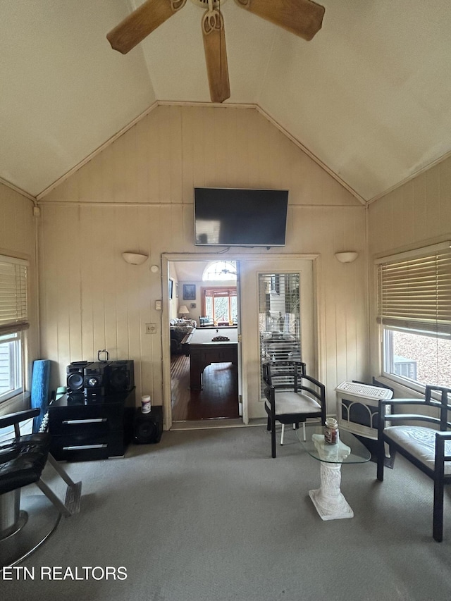 sitting room with lofted ceiling, carpet floors, and ceiling fan