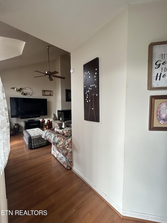 interior space featuring ceiling fan, lofted ceiling, and wood-type flooring