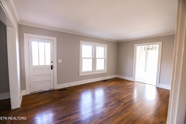 foyer featuring ornamental molding and dark hardwood / wood-style flooring