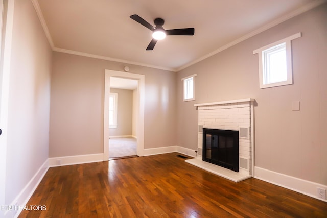 unfurnished living room featuring dark hardwood / wood-style floors, ornamental molding, and a fireplace