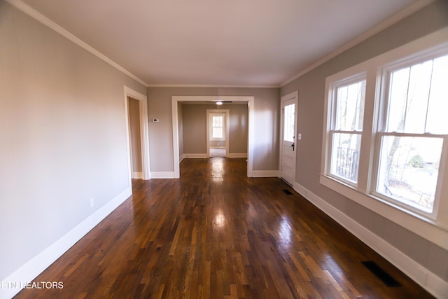 spare room with dark wood-type flooring and ornamental molding