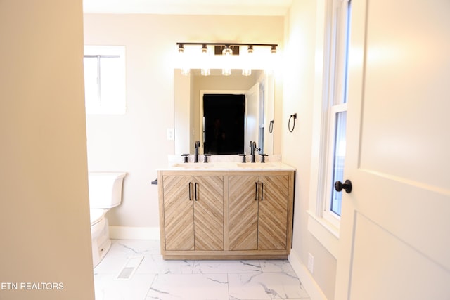 bathroom with vanity and toilet