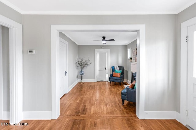 corridor featuring crown molding and light wood-type flooring