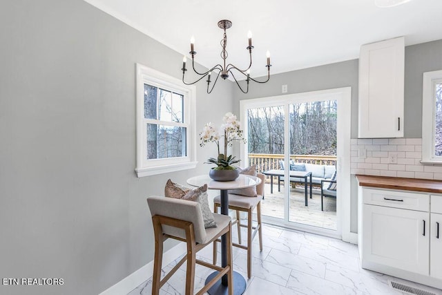 dining room featuring a notable chandelier and a wealth of natural light