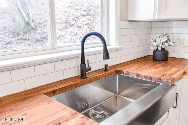 room details with sink, wooden counters, and decorative backsplash