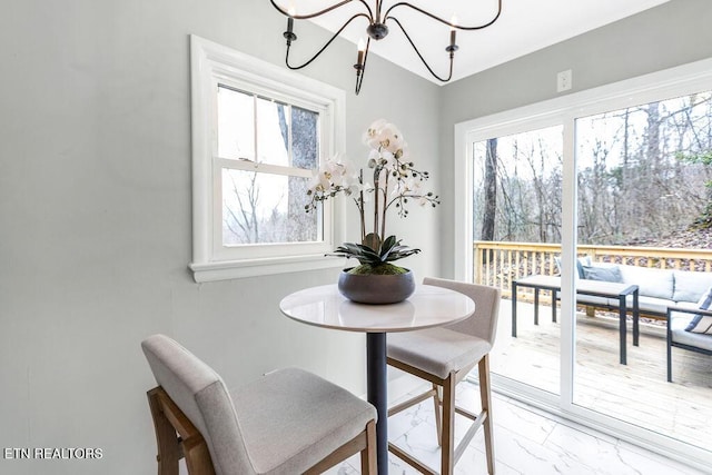 dining room with an inviting chandelier and a healthy amount of sunlight