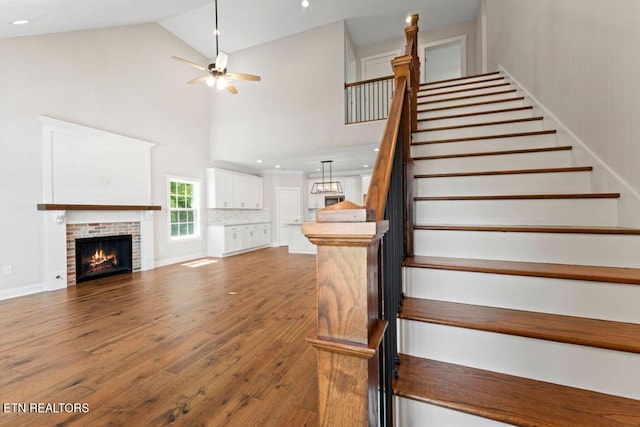 295 Caulderwood Ln, Lenoir City, TN 37771 - stairs with high vaulted ceiling, a fireplace, ceiling fan, wood finished floors, and recessed lighting
