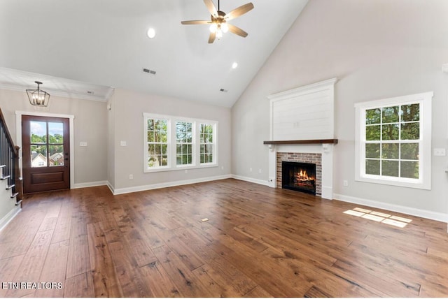 295 Caulderwood Ln, Lenoir City, TN 37771 - unfurnished living room featuring a fireplace, a healthy amount of sunlight, stairway, and hardwood / wood-style flooring