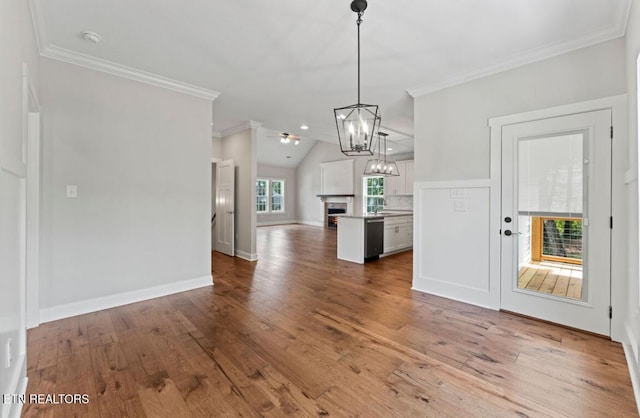 295 Caulderwood Ln, Lenoir City, TN 37771 - kitchen featuring crown molding, a fireplace, white cabinetry, open floor plan, and hardwood / wood-style floors