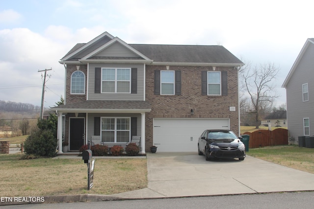 view of front of house with a garage, central air condition unit, and a front lawn