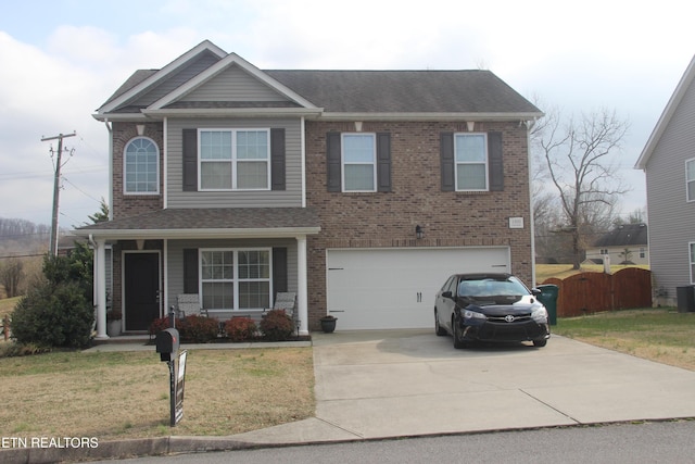 view of front facade featuring a garage, covered porch, and a front lawn