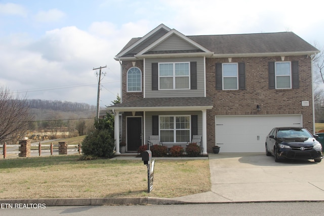 view of front facade with a garage, a front lawn, and a porch