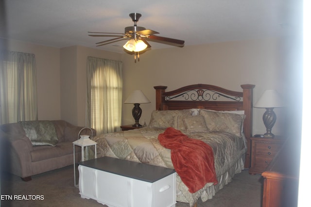 bedroom featuring ceiling fan and dark carpet