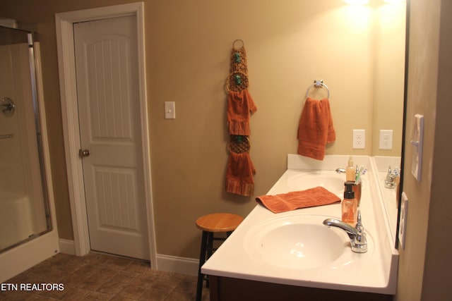 bathroom with vanity and a shower with shower door