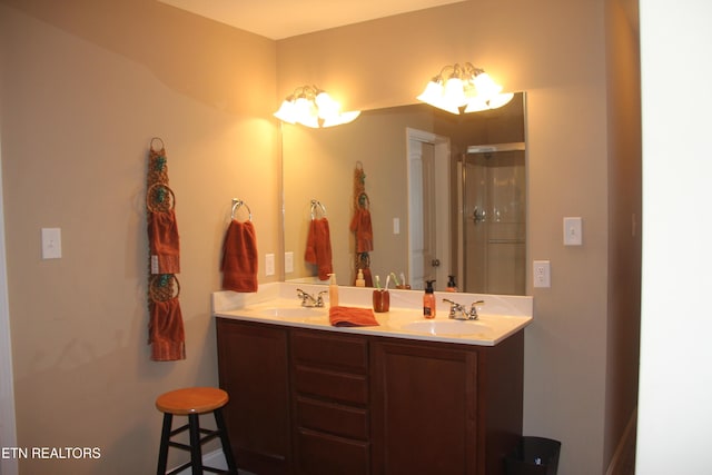 bathroom featuring vanity and a shower with shower door