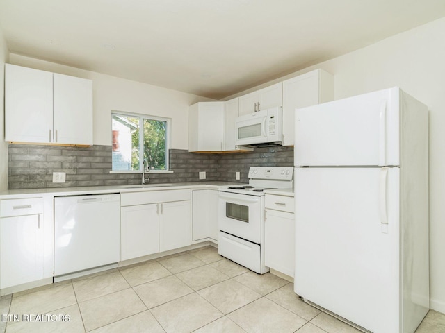 kitchen featuring tasteful backsplash, sink, white appliances, and white cabinets