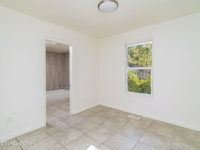 unfurnished room featuring light tile patterned floors