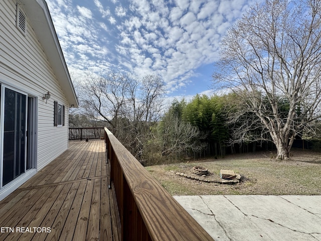 wooden deck with a fire pit