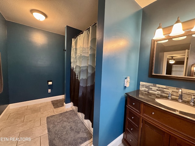 bathroom with tasteful backsplash, vanity, and tile patterned flooring