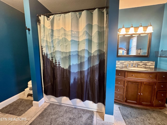 bathroom featuring a shower with curtain, tile patterned floors, vanity, and backsplash