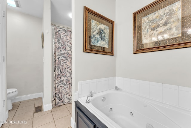 bathroom featuring tile patterned floors, toilet, and a washtub