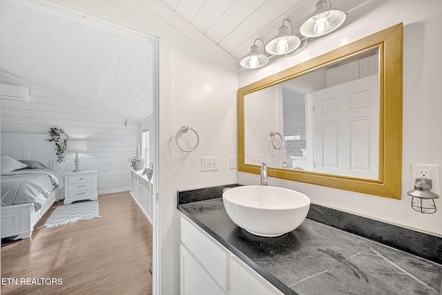 bathroom featuring vanity, wood ceiling, vaulted ceiling, and wood-type flooring