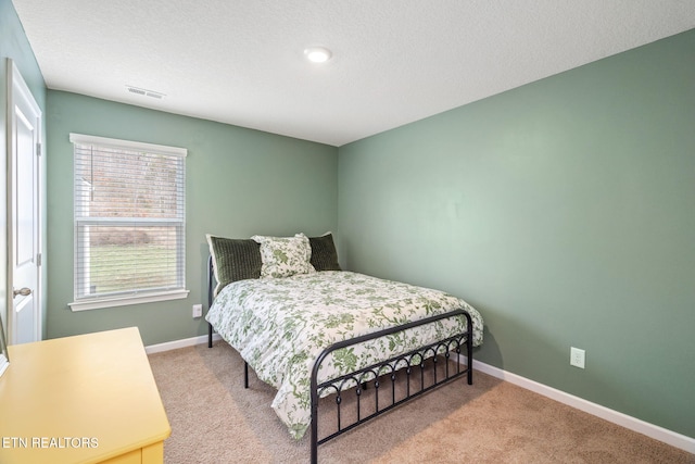 carpeted bedroom featuring a textured ceiling