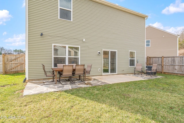 back of property featuring a patio and a yard