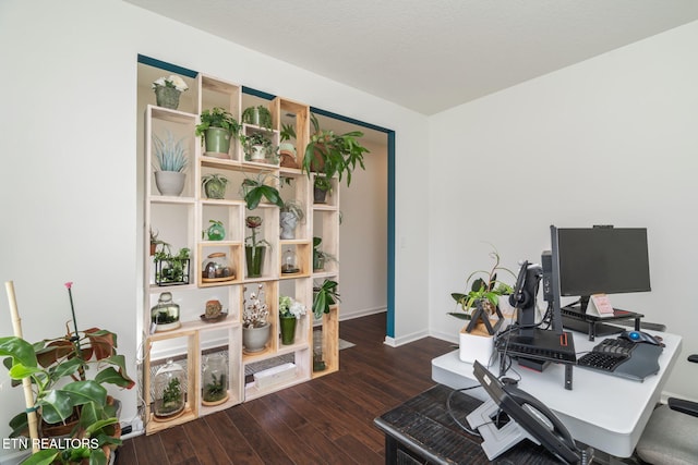 home office with dark hardwood / wood-style flooring