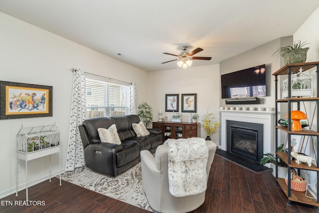 living room with dark wood-type flooring and ceiling fan