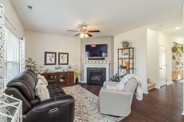 living room with ceiling fan and dark hardwood / wood-style floors