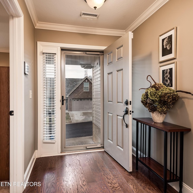 doorway to outside featuring dark hardwood / wood-style flooring, crown molding, and a healthy amount of sunlight