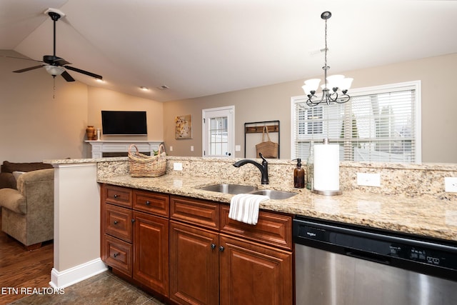 kitchen with stainless steel dishwasher, plenty of natural light, sink, and lofted ceiling