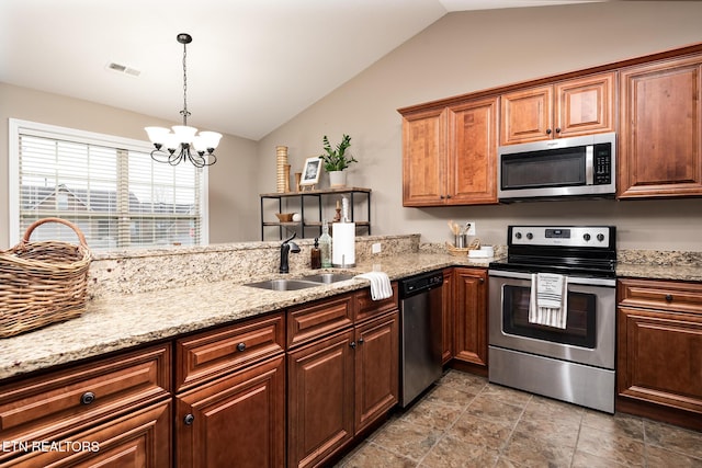 kitchen featuring sink, light stone counters, vaulted ceiling, hanging light fixtures, and stainless steel appliances