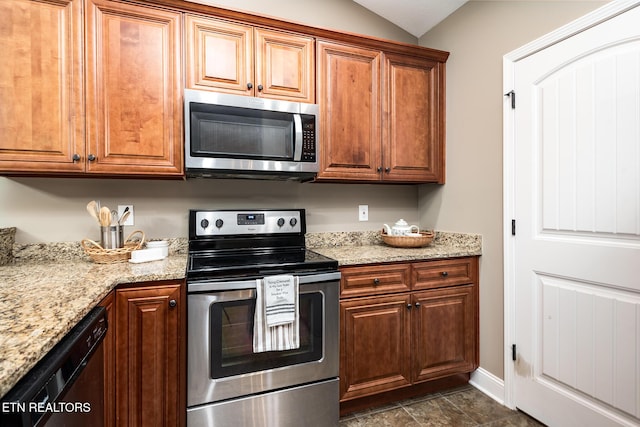 kitchen featuring lofted ceiling, appliances with stainless steel finishes, and light stone countertops