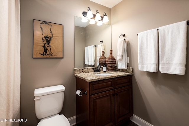 bathroom featuring vanity and toilet