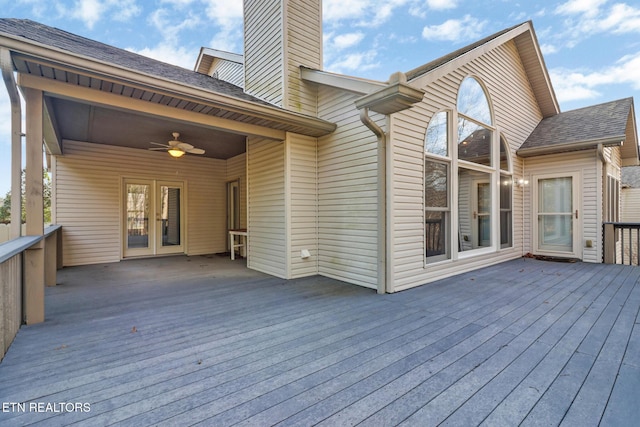 deck with a carport, french doors, and a ceiling fan