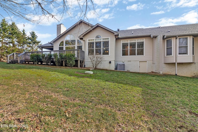 back of property featuring a wooden deck, a lawn, cooling unit, and a chimney