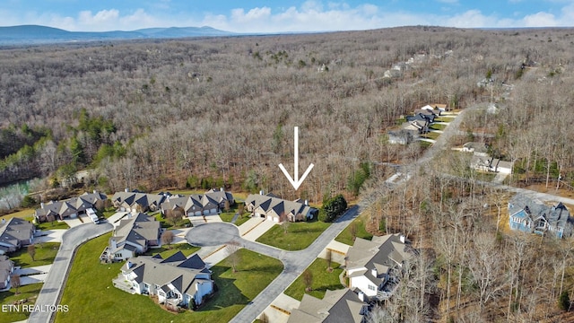 aerial view featuring a residential view, a mountain view, and a forest view