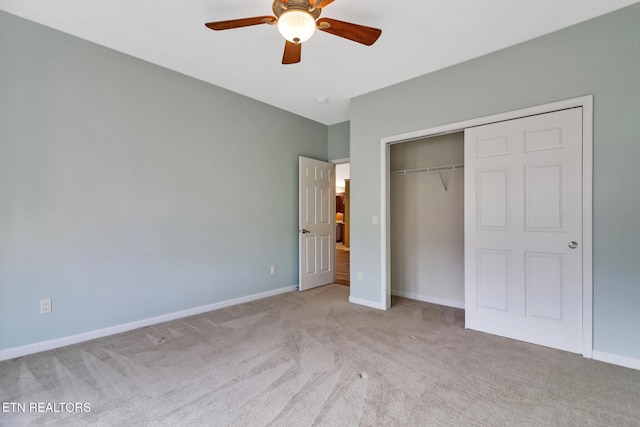 unfurnished bedroom featuring a closet, baseboards, carpet floors, and ceiling fan